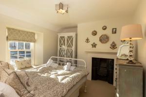 a bedroom with a bed and a fire place at Sandpiper Alnmouth in Alnmouth