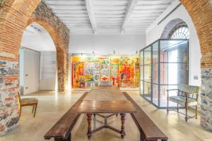 a large room with a wooden table in the middle at Garibaldi Art Apartment in Piombino