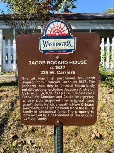 a sign for aogan board house in front of a house at The Courtableau Cottage in Washington +6 photos