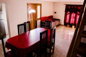 a living room with a table and a couch at Departamentos Malargue in Malargüe