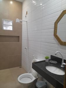 a bathroom with a toilet and a sink and a mirror at Aguas de Alter in Santarém +17 photos