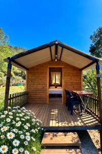 a pavilion with a table and chairs on a deck at Adrasan Camping in Kumluca