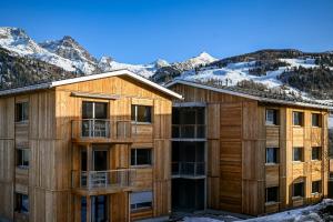 an apartment building with mountains in the background at Residenza Pazzola in Disentis