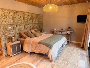 a bedroom with a bed and a television in it at Refuge des Dunes in Marck