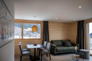 a living room with a couch and a table at Residenza Pazzola in Disentis