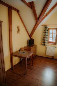 a room with a wooden table in a attic at Chalupa Chudobka in Janske Lazne