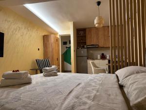 a bedroom with a bed with two towels on it at PRESTIGE studio Krusevac in Kruševac