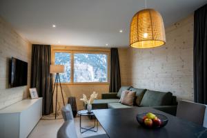 a living room with a couch and a table at Residenza Pazzola in Disentis