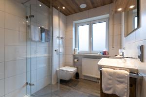 a bathroom with a shower and a sink and a toilet at Gästehaus Sonner in Dietmannsried +21 photos
