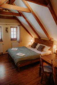 a bedroom with a large bed in a attic at Chalupa Chudobka in Janske Lazne