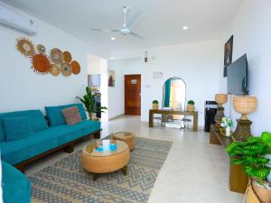 a living room with a blue couch and a table at Chui de eagle in Mombasa
