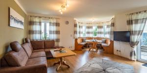 a living room with a couch and a table at Gästehaus Sonner in Dietmannsried