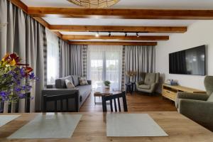 a living room with a couch and a table at Osada Hipodrom in Łąck