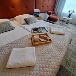 a tray of food on a bed in a hotel room at Kraków Garden Hotel - Bezpłatny parking in Krakow
