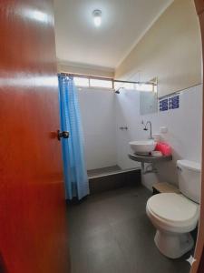 a bathroom with a toilet and a sink at La Posada de Gocta in Cocachimba