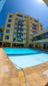 a large swimming pool in front of a building at Chui de eagle in Mombasa