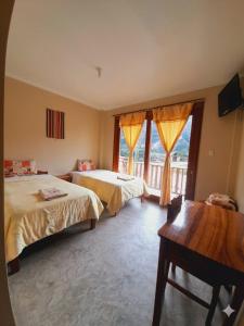 a hotel room with two beds and a window at La Posada de Gocta in Cocachimba +47 photos