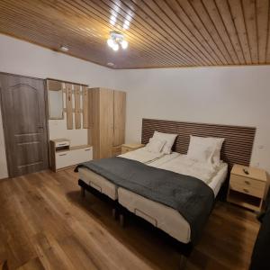 a bedroom with a large bed and a wooden ceiling at Karlskovhuset in Give