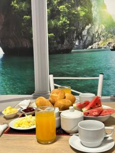 a table with food and drinks and a view of the water at Villa Arcadia Hotel & Eventos Cusco in Cusco