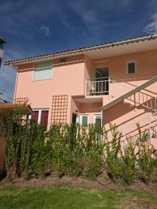 a pink house with plants in front of it at Villa Arcadia Hotel & Eventos Cusco in Cusco