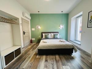 a bedroom with a bed and two pendant lights at WelcHome Vitorchiano Guest House in Vitorchiano