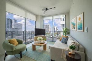 a living room with a couch and a tv at Crosby Miami World Center in Miami