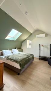 a bedroom with a bed and a skylight at Au fil de vos nuits in Lustin