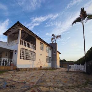 a house with a palm tree in front of it at Hotel restaurante hortencia in La Mesa