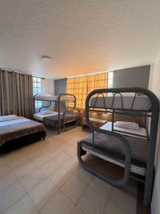 a room with three bunk beds and a window at Hotel restaurante hortencia in La Mesa +37 photos