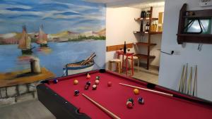 a room with a pool table and a painting at Villa Katina Supetar with private pool, pool table, barbecue in Supetar