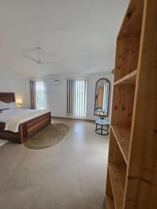 a bedroom with a large bed and a wooden closet at Paida Moyo Ocean Breeze Apartment in Zanzibar City +24 photos