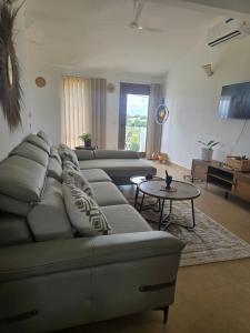 a living room with a couch and a table at Paida Moyo Ocean Breeze Apartment in Zanzibar City