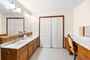 a bathroom with a sink and a large mirror at 1875 Historic Manor, 5 Acres Near Helen & Wineries in Baldwin +30 photos