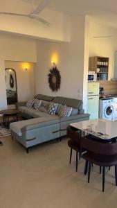 a living room with a couch and a table at Paida Moyo Ocean Breeze Apartment in Zanzibar City