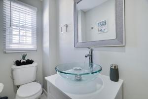 a bathroom with a glass bowl sink on top of a toilet at 2BR Apt Near EWR & NYC • Workspace + Parking in Newark