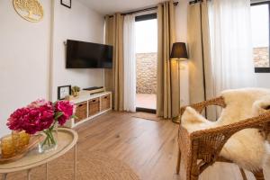 a living room with a vase of flowers on a table at Private Loft Sant Celoni, Montseny, Barcelona in Sant Celoni