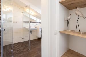a bathroom with a glass shower and a sink at Villa Fabiola in Strandnähe in Binz +87 photos