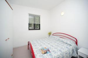 a bedroom with a bed and a window at Villaggio Turistico Grotta dell'Acqua in Peschici +34 photos