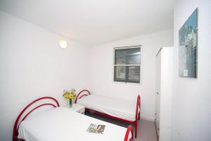 a bedroom with two beds and a window at Villaggio Turistico Grotta dell'Acqua in Peschici