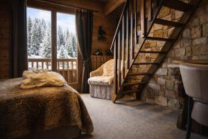 a bedroom with a staircase in a log cabin at Hôtel Chalet Alpage in La Clusaz +48 photos