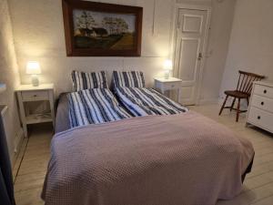 a bedroom with a bed with two tables and two lamps at Solbacken in Bjärred