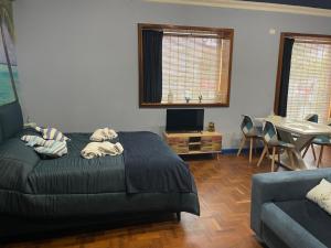 a bedroom with a bed and a couch and a table at Casa Sole in Rivoli +16 photos
