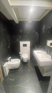 a bathroom with two sinks and a toilet at Casa Sole in Rivoli