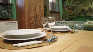 a table with plates and wine glasses on it at Casa Sole in Rivoli