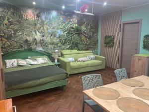 a living room with a bed and a couch and tables at Casa Sole in Rivoli