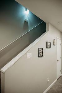 a staircase in a living room with a blue light at Freetown Blueplex Downtown Lafayette in Lafayette