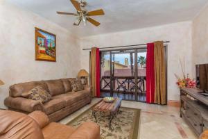 a living room with a couch and a table at Unique Colorful Condo on 3rd Floor Pinacate 321 in Puerto Peñasco