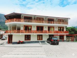 a building with a car parked in front of it at La Posada de Gocta in Cocachimba