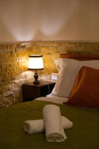 a bedroom with a bed and a lamp on a table at Casa Vacanze Dolce Angelo in Sutri