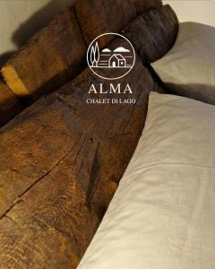 a close up of a bed with a sign on it at Alma Capodimonte Lake chalet in Capodimonte